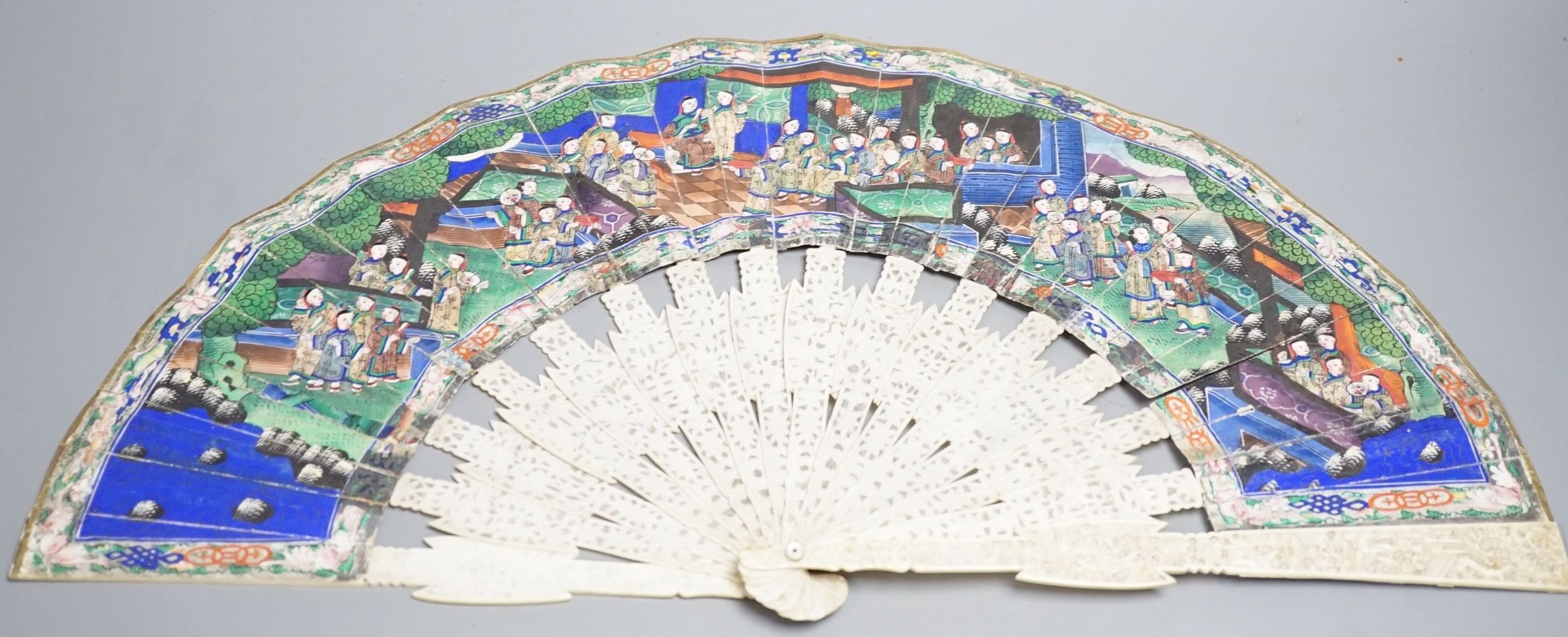 A 19th century Chinese export pierced ivory and painted paper leaf fan, in box. Fan 28cm long